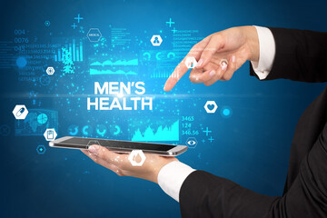 Close-up of a touchscreen with MEN’S HEALTH inscription, medical concept