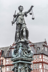 Fototapeta na wymiar Statue of Lady Justice in front of the Romer at Romerberg (Romerplatz) in Frankfurt am Main, Germany.