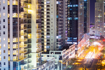 Fototapeta na wymiar Apartment windows at night in big city highrises.