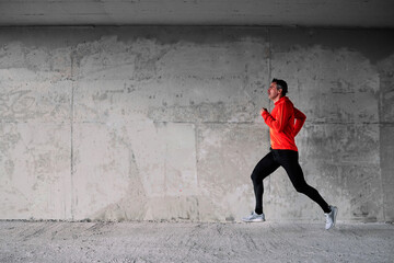 Middle-aged unshaven caucasian sportsman running outdoors.