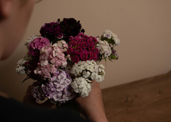 a bouquet of flowers held in hand

