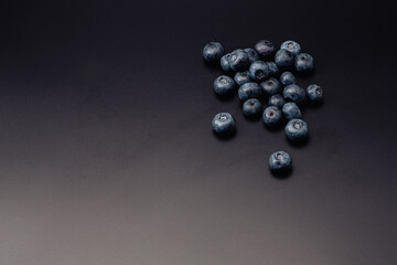 Fresh organic blueberries isolated on black background with copy space for text