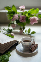 cup of tea and a bouquet of flowers