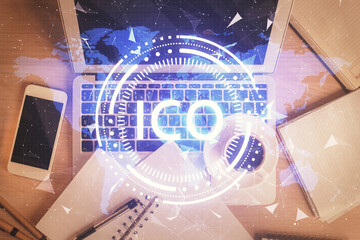 Blockchain theme hologram drawings over computer on the desktop background. Top view. Double...