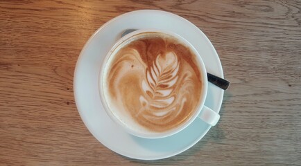 close up of a cup of coffee with a spoon 