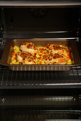 Stuffed chicken breast fillet, baked with vegetables in the oven. Cooking home-made dishes for a holiday. Recipe book.