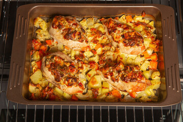 Stuffed chicken breast fillet, baked with vegetables in the oven. Cooking home-made dishes for a holiday. Recipe book.