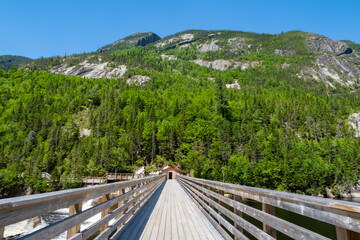 Young woman sitting at the summit of the "Mont-du-lac-des-cygnes" in Charlevoix, Quebec