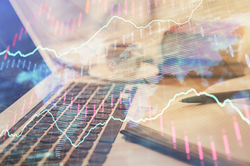 Double exposure of financial chart drawing and desktop with coffee and items on table background. Concept of forex market trading