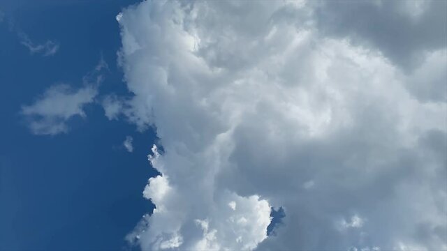 Building motions clouds. Puffy fluffy white clouds sky time lapse. slow moving clouds. The formation of an anticyclone. Swirl of clouds.