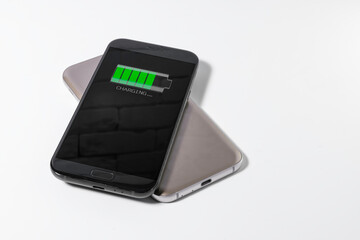 Smartphone being charged by another device via wireless charging