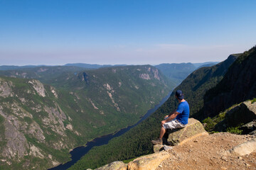 Young man sitting at the top of the 