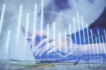 Multi exposure of woman hands typing on computer and financial graph hologram drawing. Stock market analysis concept.
