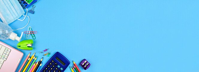 School supplies and coronavirus prevention items. Corner border on a blue paper banner background....