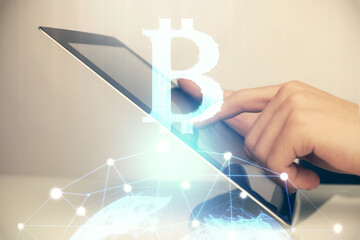 Double exposure of man's hands holding and using a phone and crypto currency blockchain theme...