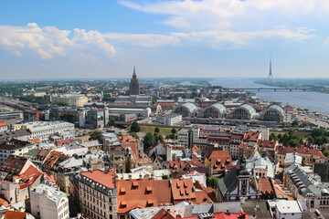 Fototapeta na wymiar Panoramic view of Riga. Market, TV tower, red roofs of old town, Daugava river.
