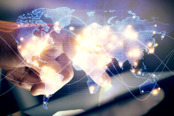 Fototapeta premium Double exposure of man's hands holding and using a phone and international business theme drawing.