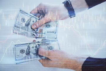 Multi exposure of financial graph drawing hologram and USA dollars bills and man hands. Analysis concept.