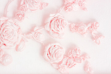 Pink rose buds on a wall with venetian stucco. Delicate image for a wedding card, invitation, business cards