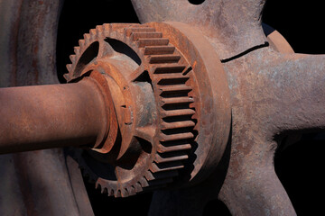 Rusty cogwheel on black