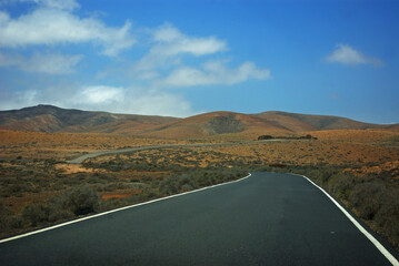road between mountains in arid terrain