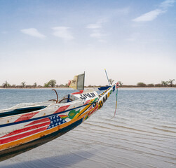 Fisher boat with Senegalese flag on the beach