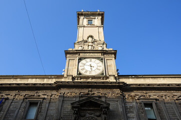 Fototapeta na wymiar Ancient clock tower of the Giureconsulti Palace also known as Palazzo Affari. Milan, Italy