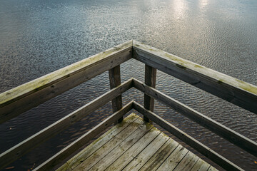 Wooden platform over water, during the sunset on a summer day - Powered by Adobe