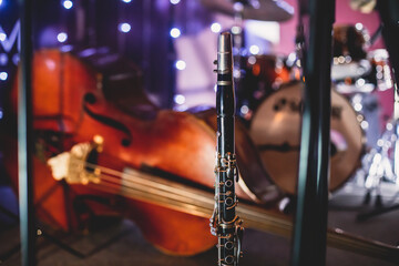 Set of musical instruments on a stage before jazz concert - clarinet, contrabass, drum set kit and...