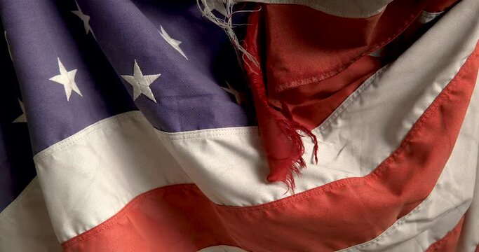 US flag faded torn old.