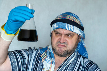 oil prices down. man in Arabic clothing holds a flask of oil. dissatisfaction with falling prices for petroleum products. crisis, changes in price quotations for black gold.
