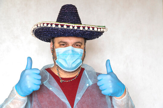 end of quarantine coronavirus COVID-19. man in a medical mask. hand with medical glove.  guy wears a Spanish or Mexican sombrero