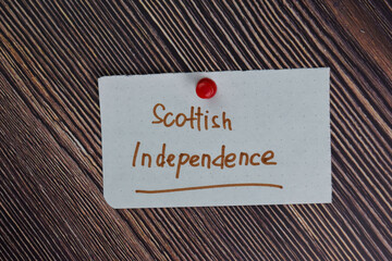 Scottish Independence text on sticky notes isolated on office desk.