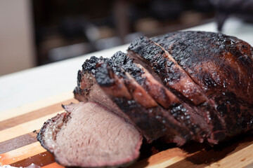 Grilled beef steak cut on a wooden board - home barbecue - cooking grilled meat