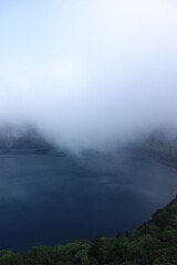 Onami-lake(old crater) covering fog in Kirishima mountain range in the early morning, Miyazaki, Japan