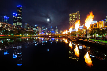 Fototapeta na wymiar Moonrise over Melbourne city with the Corwn Casino fireballs are at display