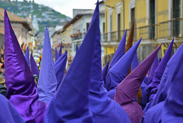 The procession of the cucuruchos in Quito, Ecuador, during Easter. Penitents put a purple robe and...