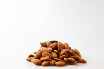 Natural organic almonds nuts heap Isolated on a white background is useful to help neutralize free radicals, help prevent Alzheimer's disease, helping repair the wear and tear on body healthy food.