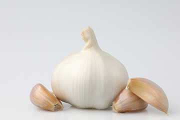 Raw garlic with garlic cloves segment use is the spice for cooking food beneficial to the body on white background. with copy space and clipping path.