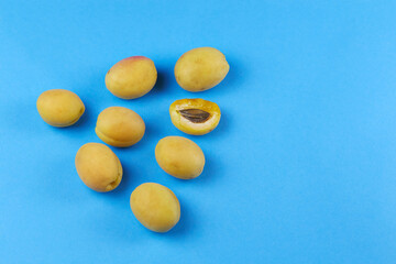 Ripe apricots  on a blue background