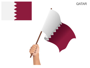 The flag of the State of Qatar that is hoisted with a stick held by hand to ignite the spirit of statehood