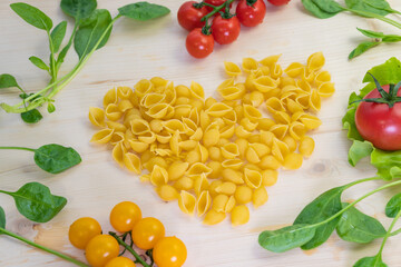 Love for pasta. Top view on the table. Product Layout. Ingredients for Italian pasta tomatoes, herbs, cherry.