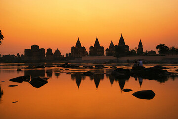 Cenotaphs (Chhatris) on the bank of the Betwa River at sunset. Orchha, Madhya Pradesh, India