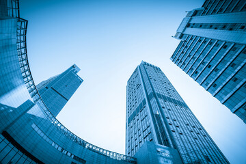 Naklejka premium Looking Up Blue Modern Office Building