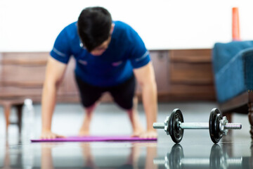Fototapeta na wymiar Mature Asian man Doing Exercises at Home. workout at home. social distancing.