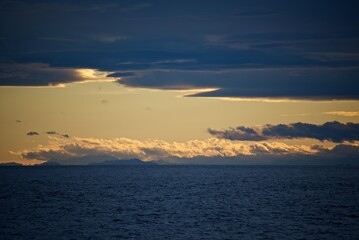 The coast of Japan is far above the horizon. Islands in the sea. Fall.