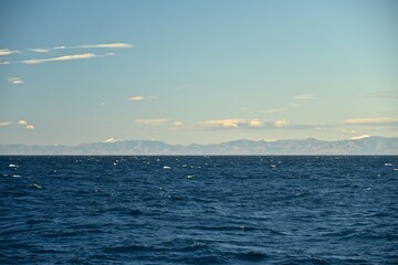 Steep shores of the Kuril Islands. Islands in the sea. Fall.