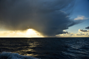Epic cloud cover over the Pacific Ocean. Photo from the side of the ship. Autumn windy evening.