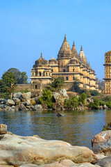 Fototapeta premium Water rafting on Betwa river in front of Royal cenotaphs (Chhatris). Orchha, Madhya Pradesh, India.