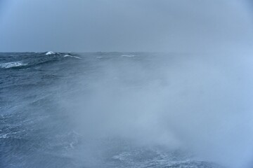 High waves on the high seas. Inside a typhoon in the Pacific Ocean. The hard work of sailors.